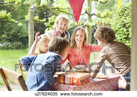 Family singing and cheering at birthday party View Large Photo Image Stock Photography - Family singing and cheering at birthday party. Fotosearch