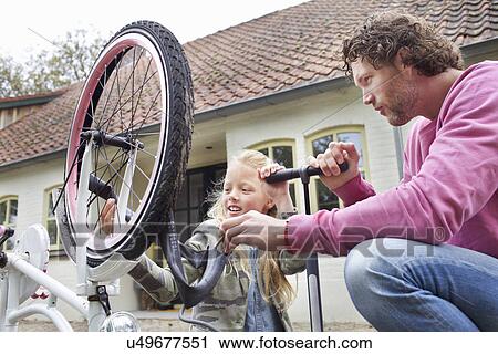 Father and daughter mending bike View Large Photo Image Stock Image - Father and daughter mending bike. Fotosearch