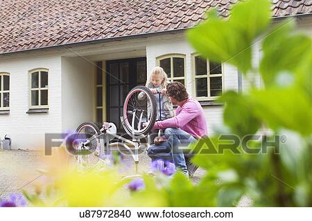 Father and daughter mending bike View Large Photo Image Stock Image - Father and daughter mending bike. Fotosearch