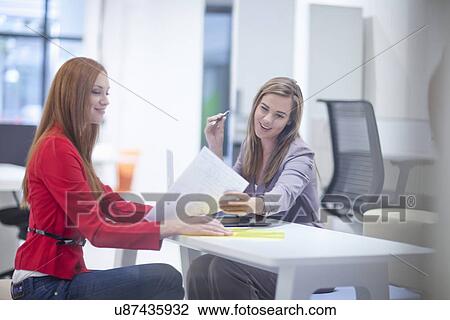 Female colleagues with paperwork View Large Photo Image Stock Image - Female colleagues with paperwork. Fotosearch