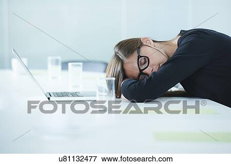 Female office worker asleep at conference table View Large Photo Image Stock Photo - Female office worker asleep at conference table. Fotosearch