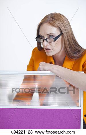 Female office worker leaning on partition View Large Photo Image Stock Photo - Female office worker leaning on partition. Fotosearch