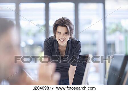 Stock Photo - Female office worker smiling, portrait. Fotosearch