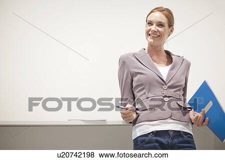 Stock Photo - Female office worker smiling, portrait. Fotosearch