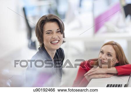Stock Photograph - Female office worker smiling. Fotosearch