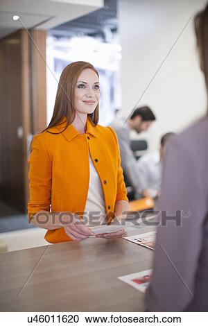 Female office worker wearing orange jacket, portrait View Large Photo Image Stock Image - Female office worker wearing orange jacket, portrait. Fotosearch