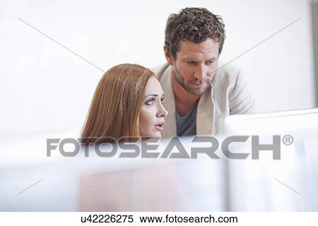 Female office worker with colleague, looking worried View Large Photo Image Stock Photography - Female office worker with colleague, looking worried. Fotosearch