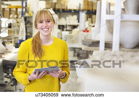 Female potter using digital tablet in ceramic workshop View Large Photo Image Stock Photo - Female potter using digital tablet in ceramic workshop. Fotosearch