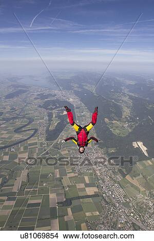 Female skydiver free falling upside down over Grenchen, Berne, Switzerland View Large Photo Image Picture - Female skydiver free falling upside down over Grenchen, Berne, Switzerland. Fotosearch