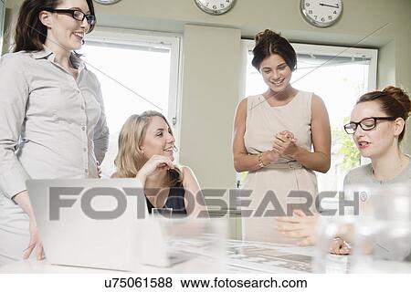Four businesswomen at presentation meeting in conference room View Large Photo Image Stock Photo - Four businesswomen at presentation meeting in conference room. Fotosearch