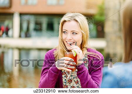 Stock Image - Friends drinking by canal. Fotosearch