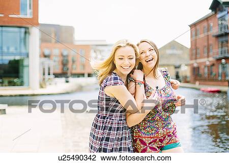 Friends fooling around by canal, Leeds, England View Large Photo Image Stock Image - Friends fooling around by canal, Leeds, England. Fotosearch