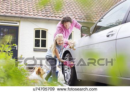 Stock Photo - Girl helping father wash his car. Fotosearch