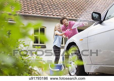 Stock Photograph - Girl helping father wash his car. Fotosearch