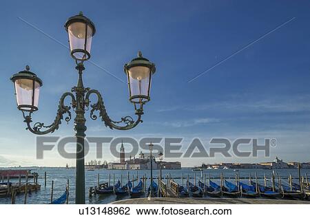 Stock Image - Gondolas and the Island of San Giorgio Maggiore, from St Mark's Square, Venice, Veneto, Italy. Fotosearch