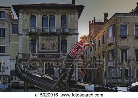 Stock Photograph - Gondolier on Grand canal, Venice, Veneto, Italy. Fotosearch