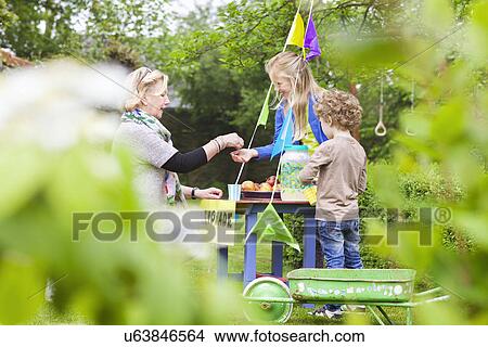Grandmother buying lemonade from grandchildren's stand View Large Photo Image Picture - Grandmother buying lemonade from grandchildren's stand. Fotosearch
