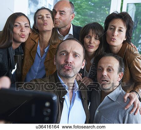 Group of people taking self portrait photograph View Large Photo Image Picture - Group of people taking self portrait photograph. Fotosearch