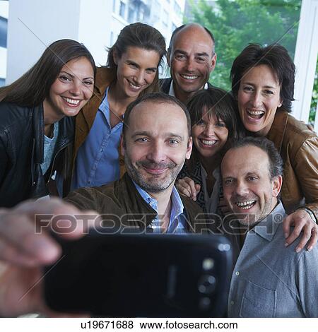 Group of people taking self portrait photograph View Large Photo Image Stock Photo - Group of people taking self portrait photograph. Fotosearch