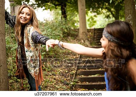 Hippy girls holding hands View Large Photo Image Stock Image - Hippy girls holding hands. Fotosearch
