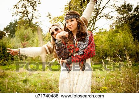 Stock Photograph - Hippy girls in a field. Fotosearch