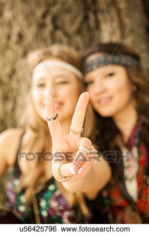 Hippy women showing peace sign View Large Photo Image Stock Photograph - Hippy women showing peace sign. Fotosearch