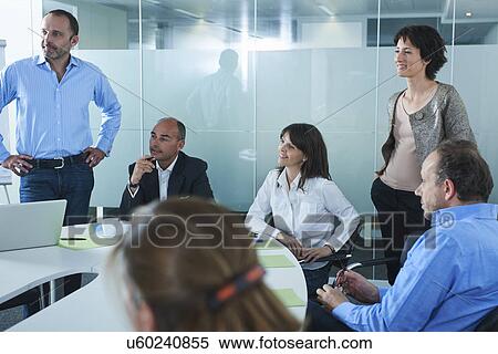 Informal business meeting around boardroom table View Large Photo Image Stock Photography - Informal business meeting around boardroom table. Fotosearch