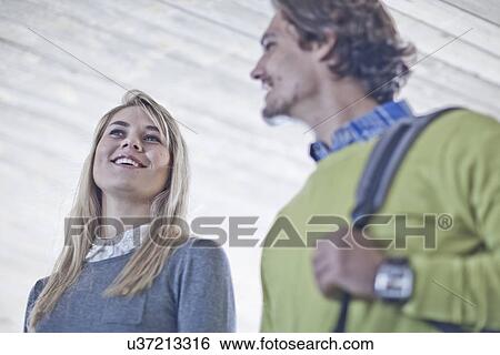 Stock Photograph - Low angle view of couple chatting in city underpass. Fotosearch