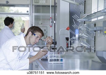 Male and female scientists working in lab View Large Photo Image Stock Image - Male and female scientists working in lab. Fotosearch