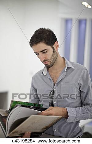 Male office worker reading book View Large Photo Image Picture - Male office worker reading book. Fotosearch
