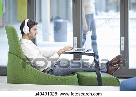 Male office worker using laptop View Large Photo Image Stock Photo - Male office worker using laptop. Fotosearch