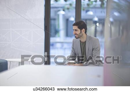 Male office worker wearing grey jacket, portrait View Large Photo Image Stock Image - Male office worker wearing grey jacket, portrait. Fotosearch