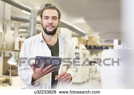 Male potter using digital tablet in ceramic workshop View Large Photo Image Stock Photo - Male potter using digital tablet in ceramic workshop. Fotosearch