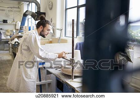 Male potter working in ceramic workshop View Large Photo Image Stock Image - Male potter working in ceramic workshop. Fotosearch