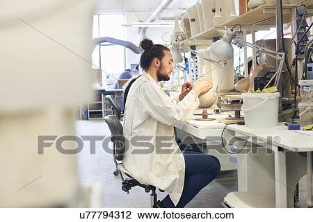 Male potter working in ceramic workshop View Large Photo Image Stock Image - Male potter working in ceramic workshop. Fotosearch