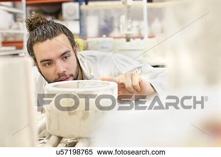 Male potter working on cylindrical shape in ceramic workshop View Large Photo Image Stock Photography - Male potter working on cylindrical shape in ceramic workshop. Fotosearch
