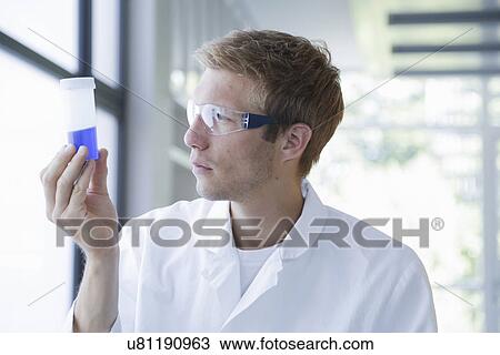 Male scientist analyzing sample in plastic bottle in lab View Large Photo Image Stock Image - Male scientist analyzing sample in plastic bottle in lab. Fotosearch