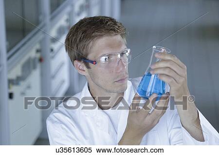 Male scientist holding up erlenmeyer flask in lab View Large Photo Image Stock Photography - Male scientist holding up erlenmeyer flask in lab. Fotosearch