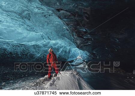 Stock Photography - Man gazing upward in ice cave, Vatnajokull Glacier, Vatnajokull National Park, Iceland. Fotosearch