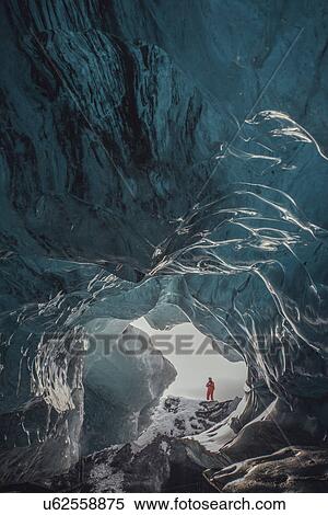 Man standing at ice cave entrance, Vatnajokull Glacier, Vatnajokull National Park, Iceland View Large Photo Image Stock Photography - Man standing at ice cave entrance, Vatnajokull Glacier, Vatnajokull National Park, Iceland. Fotosearch