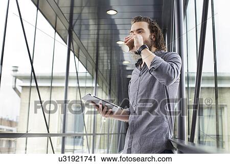 Man with digital tablet on coffee break View Large Photo Image Stock Image - Man with digital tablet on coffee break. Fotosearch
