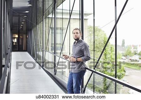 Stock Image - Man with smartphone on coffee break. Fotosearch