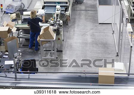 Mature woman working in paper packaging factory View Large Photo Image Stock Photo - Mature woman working in paper packaging factory. Fotosearch