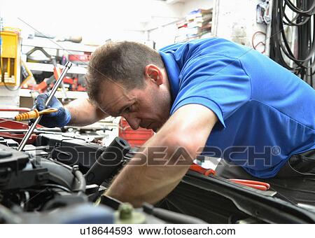 Mechanic checking car engine View Large Photo Image Stock Image - Mechanic checking car engine. Fotosearch