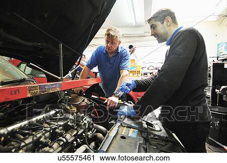 Mechanic checking car engine View Large Photo Image Stock Image - Mechanic checking car engine. Fotosearch