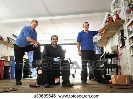 Stock Photograph - Mechanics in garage. Fotosearch