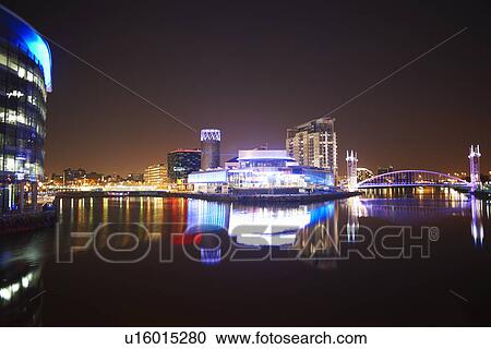 Stock Image - Media City and canal at night, Manchester, UK. Fotosearch