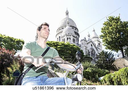 Mid adult male cycling in Paris, France View Large Photo Image Stock Photograph - Mid adult male cycling in Paris, France. Fotosearch