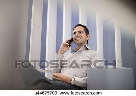 Mid adult man on smartphone View Large Photo Image Stock Photo - Mid adult man on smartphone. Fotosearch
