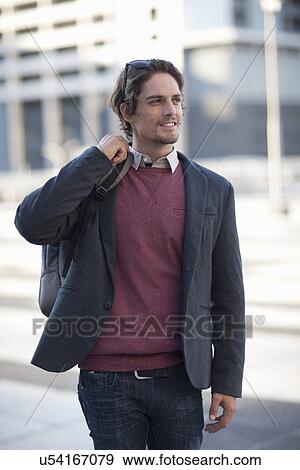 Mid adult man walking in city View Large Photo Image Stock Photo - Mid adult man walking in city. Fotosearch